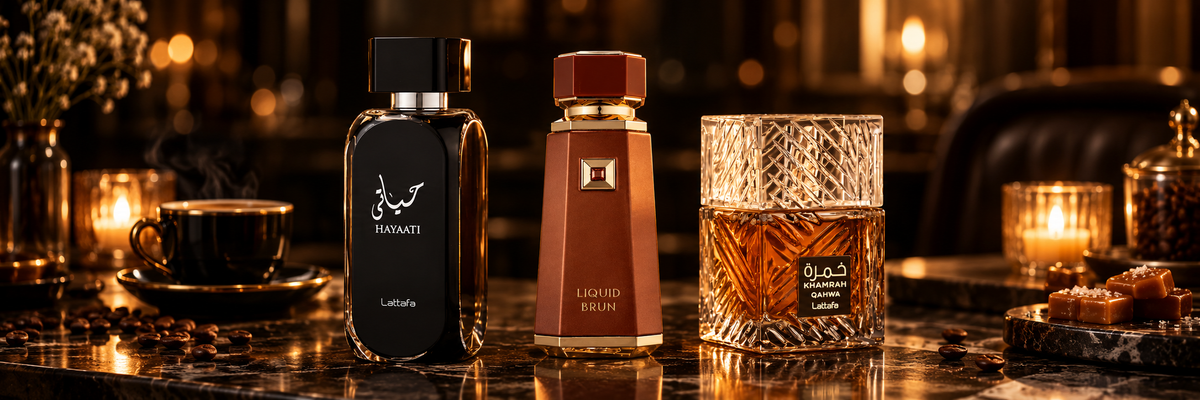 Lattafa Hayaati, French Avenue Liquid Brun and Lattafa Khamrah Qahwa fragrance bottles on a dark marble table by candlelight with espresso, coffee beans and caramels